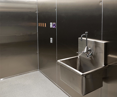 A stainless steel sink in a bathroom